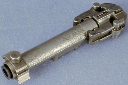MG-42,bolt assembly, with locking rollers and extractor claw seen at theright and belt-feed operating stud at the left.